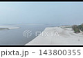 Moving drone shot of Brahmaputra River showing golden sandbanks and flowing water Moving drone shot of Brahmaputra River showing golden sandbanks and flowing water 143800355