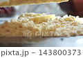 Macro Shot Chopping Fresh Butter into Flour Crumbs with Scraper 143800373