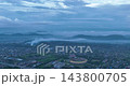 Drone panning shot from Sarusajai Stadium towards the hills capturing a serene landscape Drone panning shot from Sarusajai Stadium towards the hills capturing a serene landscape 143800705