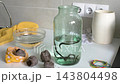 Leeches are transferred from a bag of peat into a jar of water for hirudotherapy. The setup demonstrates an alternative healing method in a clinical 143804498