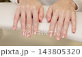 Female Client Showing Both Hands With Neat Natural Fingernails And Clear Glossy Finish After Professional Manicure. Minimalist Nail Beauty And Salon Result In Slow Motion. 143805320