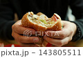 Close-up of a hungry man eating a big juicy burger in a cafe 143805511