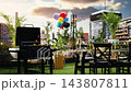 Empty rooftop barbecue setup with grill and bottled drinks on dining table near balloons, space setup for outdoor cooking party, hangout or social event. BBQ venue. 143807811