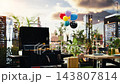 Empty rooftop party setup for outdoor dining and barbecue, featuring grill, beer bottles and food. Balloons ready for social gathering event, hangout or celebration. 143807814