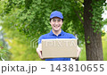 An image of a delivery staff member working in logistics or delivery services handing over a package and saying, "Your package has been delivered." 143810655