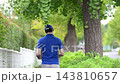 A video shows a young Japanese man walking and delivering packages in a lush green outdoor setting, his face obscured by his back. 143810657