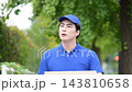 A video has been uploaded showing a young Japanese delivery man walking outdoors in the fresh greenery, carrying cardboard boxes and searching for packages. 143810658