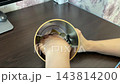 Individual sorts and examines small coins carefully. Closeup of hands handling coins for savings collection. Detailed image of fingers sorting and inspecting metallic coins for saving purposes 143814200