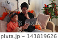 Parent and child share Halloween fun at home 143819626