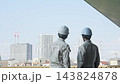 A group of male workers looking out at a city under construction. (Keywords: construction, teamwork, safety, inspection, building, site, building maintenance, inspection) 143824878
