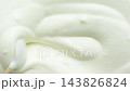 Spoon stirring fresh sour cream showing smooth texture macro 143826824