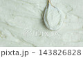 Spoonful of cottage cheese paste on smooth curd background 143826828