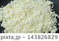 Organic crumbly curd cheese pile spinning close up video. 143826829