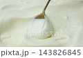 Smooth sour cream texture being stirred with spoon macro video. 143826845