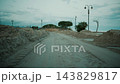 Road covered in sand by storm surge at night during a climate change 143829817