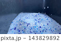 Silica gel crystals falling into a litter tray 143829892