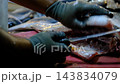 Fishmonger Cleaning Fresh Fish at a Traditional Fish Market. 143834079