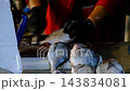 Fishmonger Cleaning Fresh Fish at a Traditional Fish Market. 143834081