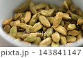 Organic oriental spice cardamom or cardamon whole ripe dried pods falling in slow motion. Macro shot 143841147