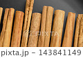 Different cinnamon sticks with rich textures and culinary potential for flavorful dishes on a black surface. Raw aromatic ingredients. Top view. Rotation 143841149