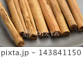Falling dry cinnamon sticks as aromatic spice for flavorful dishes. Raw organic ingredients. Slow motion 143841150