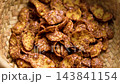 Dry healthy breakfast ingredient corn chocolate flakes in rustic wicker bowl. Macro shot. Rotation. Top view 143841154