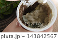 Closeup of yogurt jar completely covered with black fuzzy mold. Dangerous moldy fermented dairy product, household and food allergen 143842567