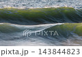 Storm wave crashing in ocean with evening warm sunlight. High quality 4k footage 143844823