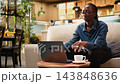 Headache on black woman working from home and feeling overwhelmed by tasks and responsibility, drained with discomfort and eye strain. Adult rubbing temples indoors, physical fatigue. 143848636