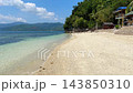 Tropical sandy beach with clear blue water palms resort house and green mountains under sunny sky in Asia 143850310