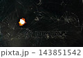 fiery burning through the black surface of cracked old black glass, transparent video template without a background for applying the burning effect, alpha channel 143851542