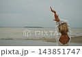 Woman Raising Arms by the Sea with Copy Space. 143851747