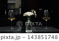 Two Drinks and White Flowers on Table in Elegant Restaurant. 143851748