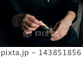 Woman Applying Skincare Oil with Dropper to Hand. 143851856