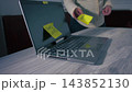 Boss throws sticky note onto laptop with urgent reminder  143852130