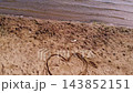 Love heart drawing in sand on lake side beach  143852151