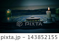 Spirit board in dark room with candles 143852155