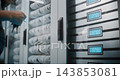 IT Technician Unlocking Server Cabinet Door with Keys 143853081