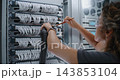 Data Center Worker in Safety Goggles Performing Routine Hardware Sanitation 143853104