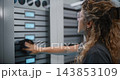Woman in STEM Performing Routine Server Room Maintenance 143853109