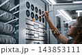 Female Network Engineer Servicing Server Cabinet Ventilation System 143853111