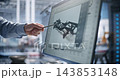 Engineer Pointing to 3D Car Chassis CAD Model on Screen 143853148