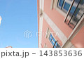 Pink building facade and balconies passing in an upward street view 143853636