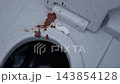 Rust stains and crumpled tissue on gray concrete surface with dark opening 143854128