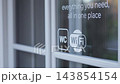 Glass storefront window with WC and WiFi signs showing service access and convenience in modern business setting 143854154