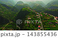 An aerial view of an incredibly beautiful green mountain valley with small villages on the hills, located on the island of Madeira, Portugal 143855436