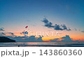 Time lapse Waves kiss the sandy beach while the fading sunlight creates a warm, romantic glow over the horizon. Serene Paradise Sunset by the Sea at Kala island Layan beach Phuket 143860360