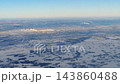Aerial view of snowy Novosibirsk from airplane window on winter day 143860488