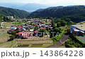 Rice stalks being sun-dried after harvest in the terraced rice fields of Hirabayashi, Fujikawa Town, Yamanashi Prefecture, with a view of Mount Fuji. 143864228