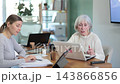 Elderly and adult women working in office  143866856